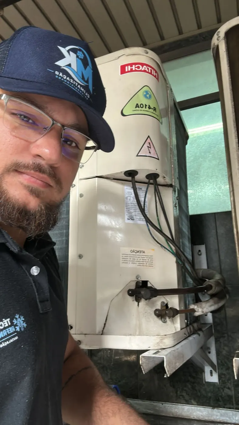 Técnico da MK Climatização inspecionando condensadora durante visita de PMOC em Belo Horizonte